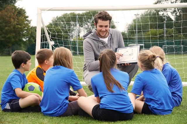 kids with soccer coach