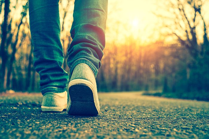 person walking outdoors at sunset