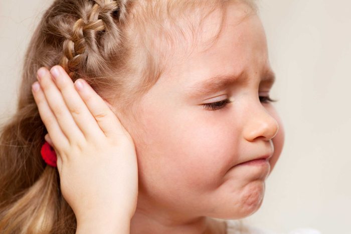 girl with hand over ear