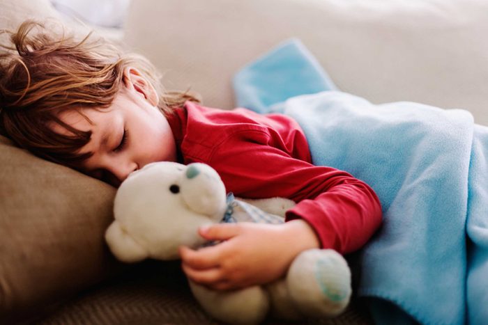 child sleeping with stuffed animal
