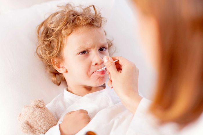 mom giving baby medicine