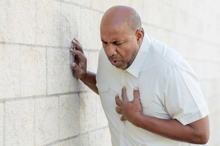 African American man in distress, hand over his chest.