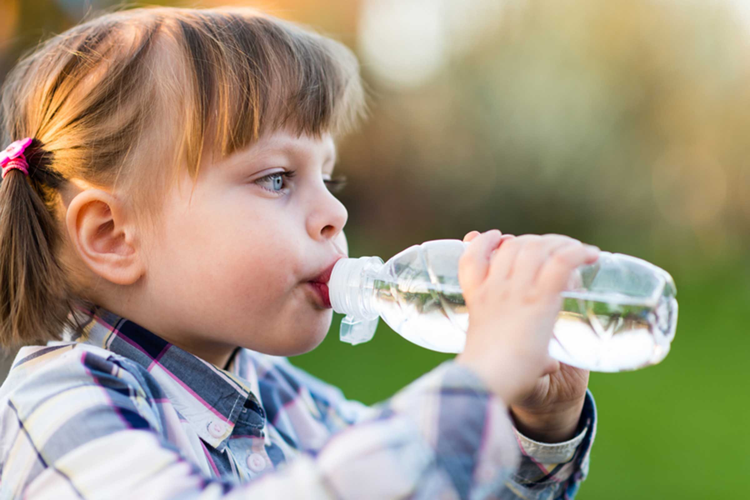 toddler girl drinking from a water bottle