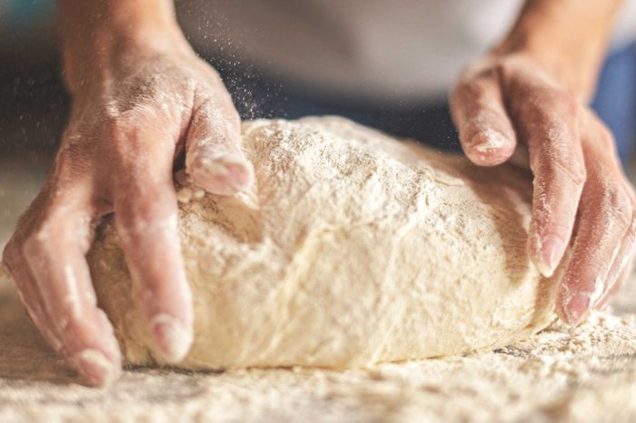 Woman kneading bread dough