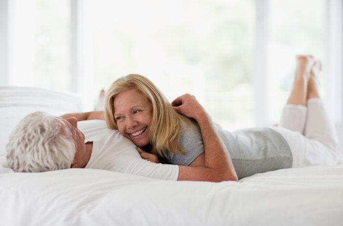 happy couple laying in bed together