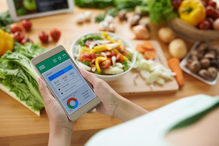 person tracking calories on phone