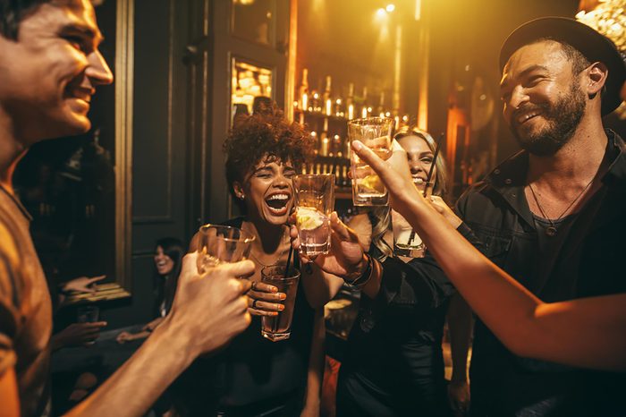 friends toasting in a bar