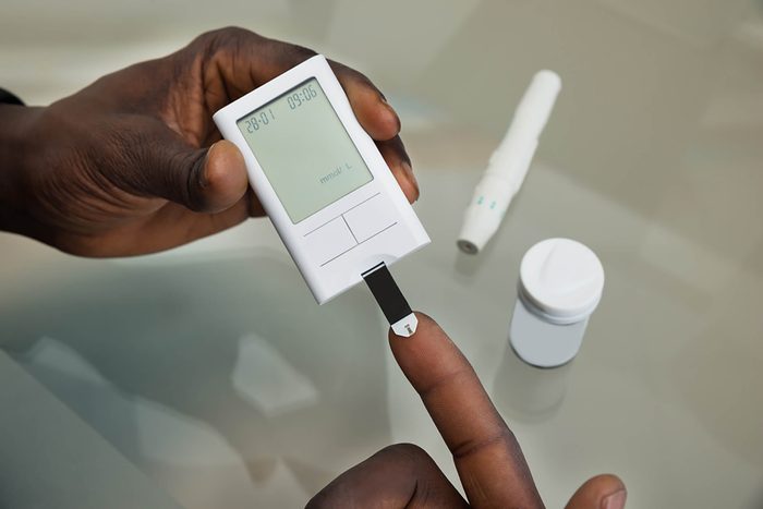 checking blood glucose with finger prick