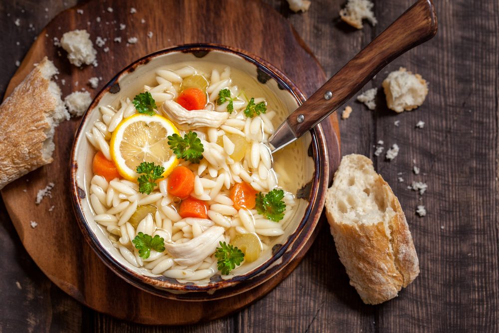 Bowl of Italian Lemon Chicken Orzo Soup. Rustic Style