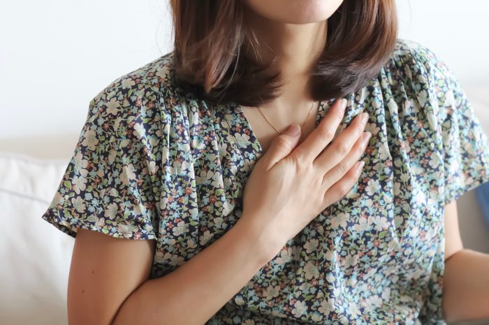 woman hand on heart chest 