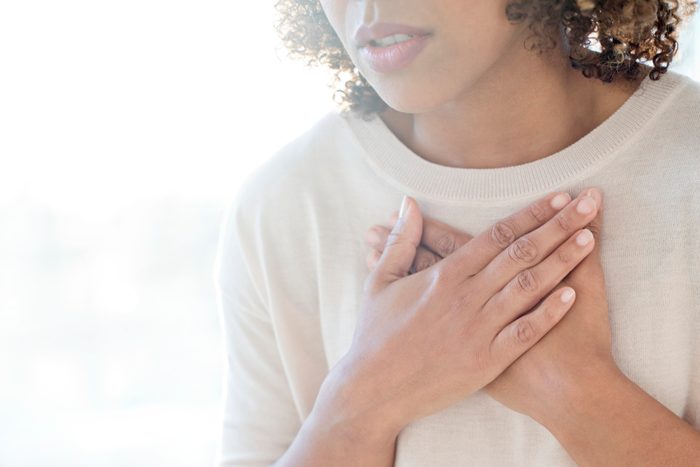 woman touching chest