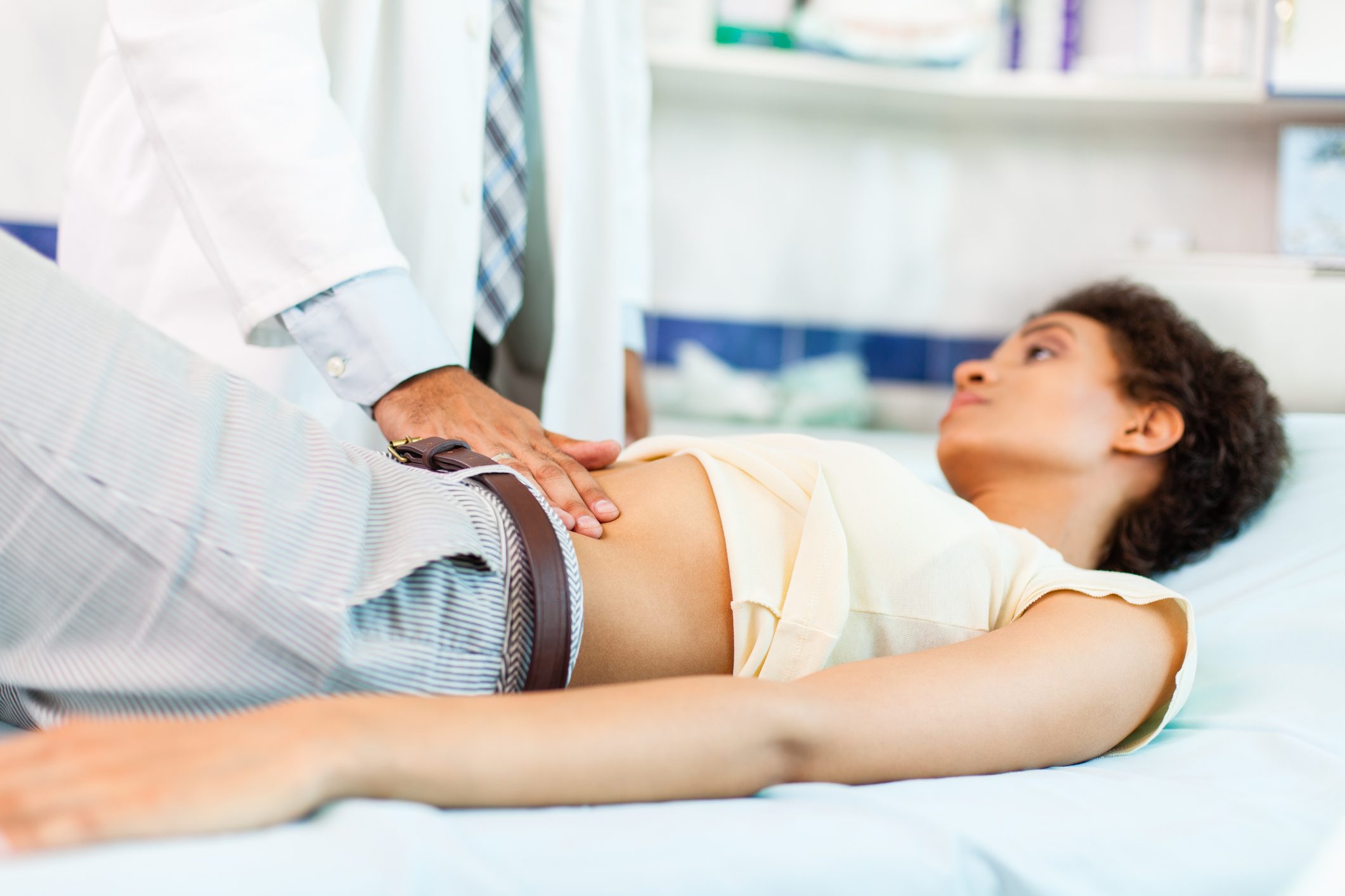 Woman with stomachache on medical exam