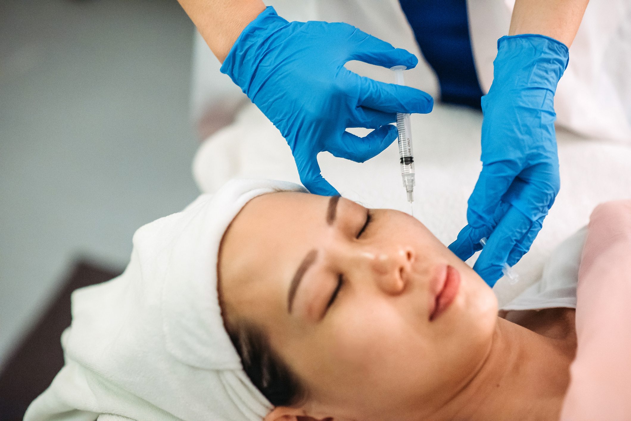 female receiving injection on the face at facial beauty salon