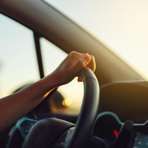 hand on steering wheel during a commute to work